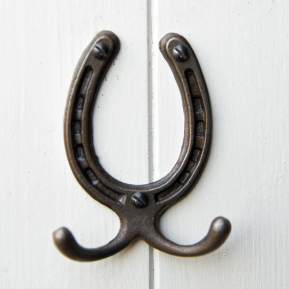 Small cast metal horseshoe shaped wall hook