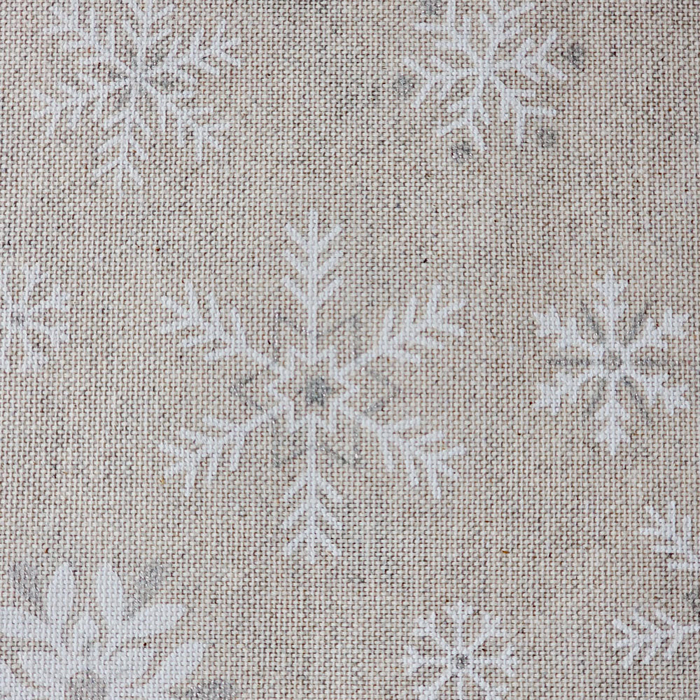 Beige woven fabric with a repeating white snowflake pattern, shown in a close-up texture view.