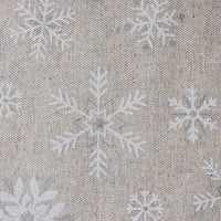 Beige woven fabric with a repeating white snowflake pattern, shown in a close-up texture view.