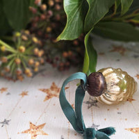 Gold glass Christmas decoration and foliage on stars wipe clean tablecloth