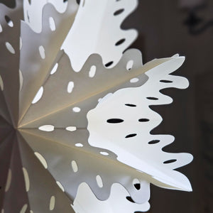 Close up of white paper snowflake retro Christmas decoration