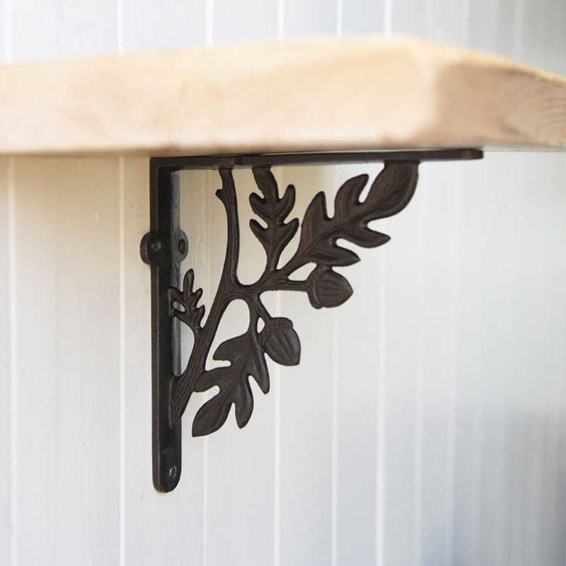 Oak leaf shelf bracket supporting a reclaimed shelf board