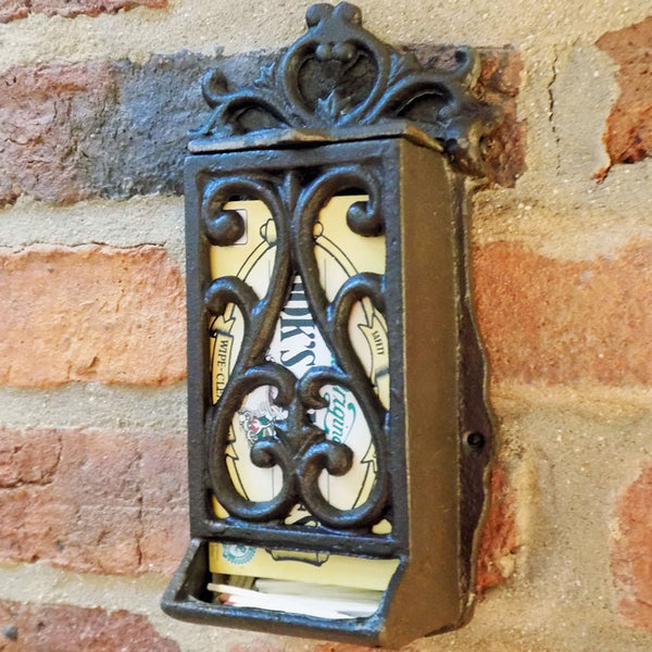 Cast iron matchbox holder mounted on a wall