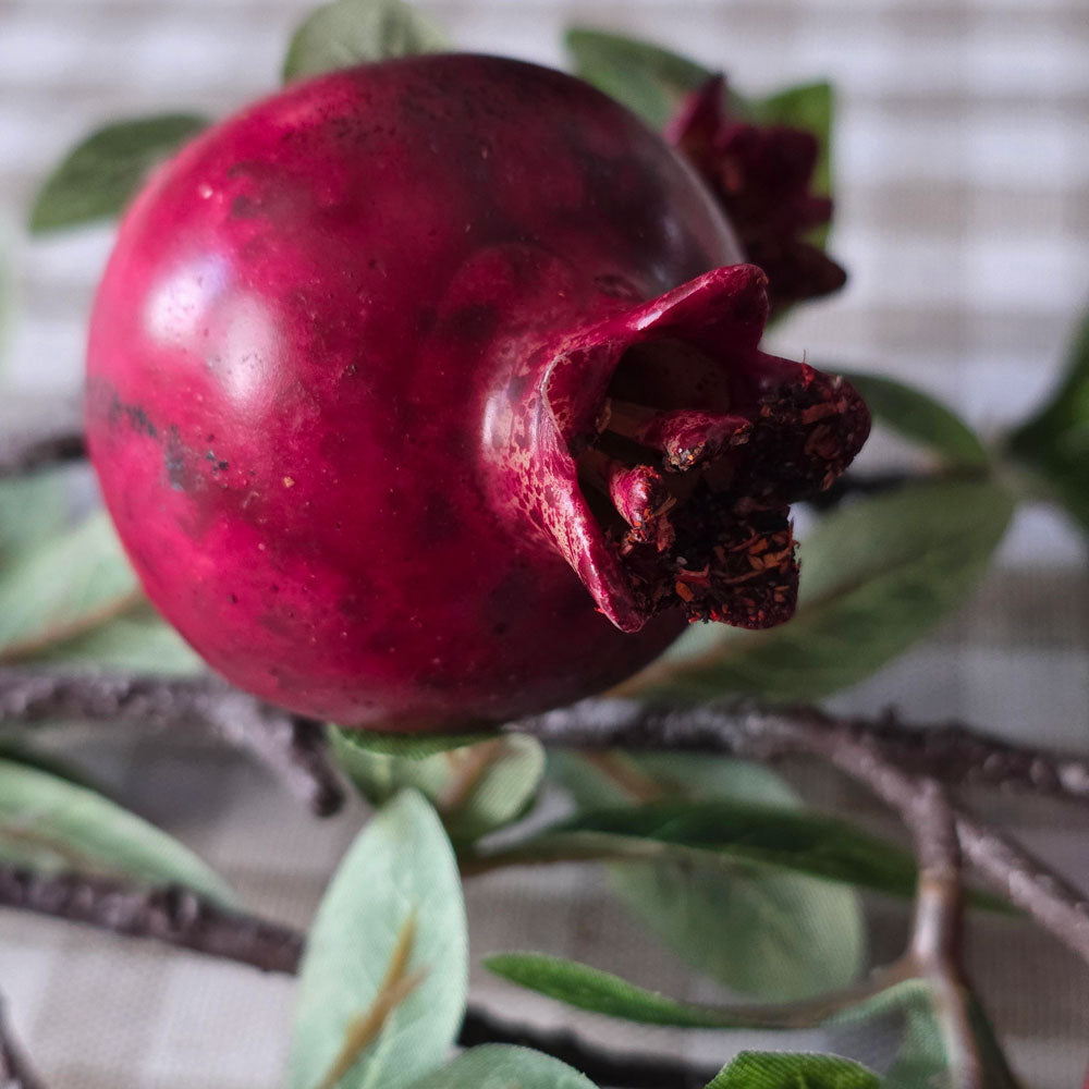 Close up of red faux pomegranate.