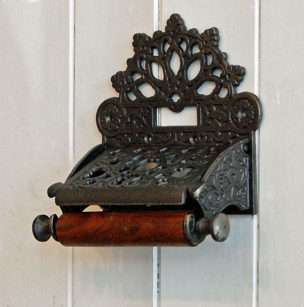 County Victorian style cast metal wall mounted toilet roll holder.