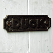 Cast metal low beam duck sign