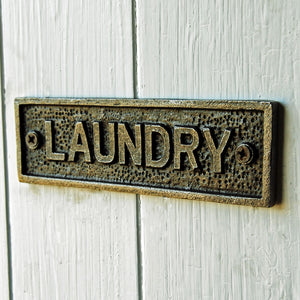 Cast metal laundry room door plate sign