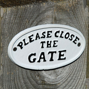 Traditional white cast metal please close the gate sign